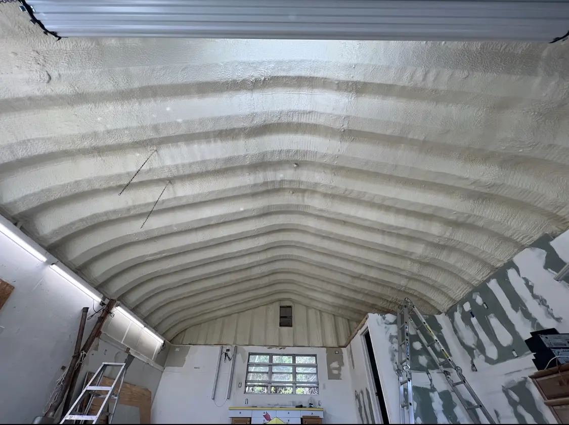 Spray polyurethane foam applied to the underside of a metal roof deck in Arnold